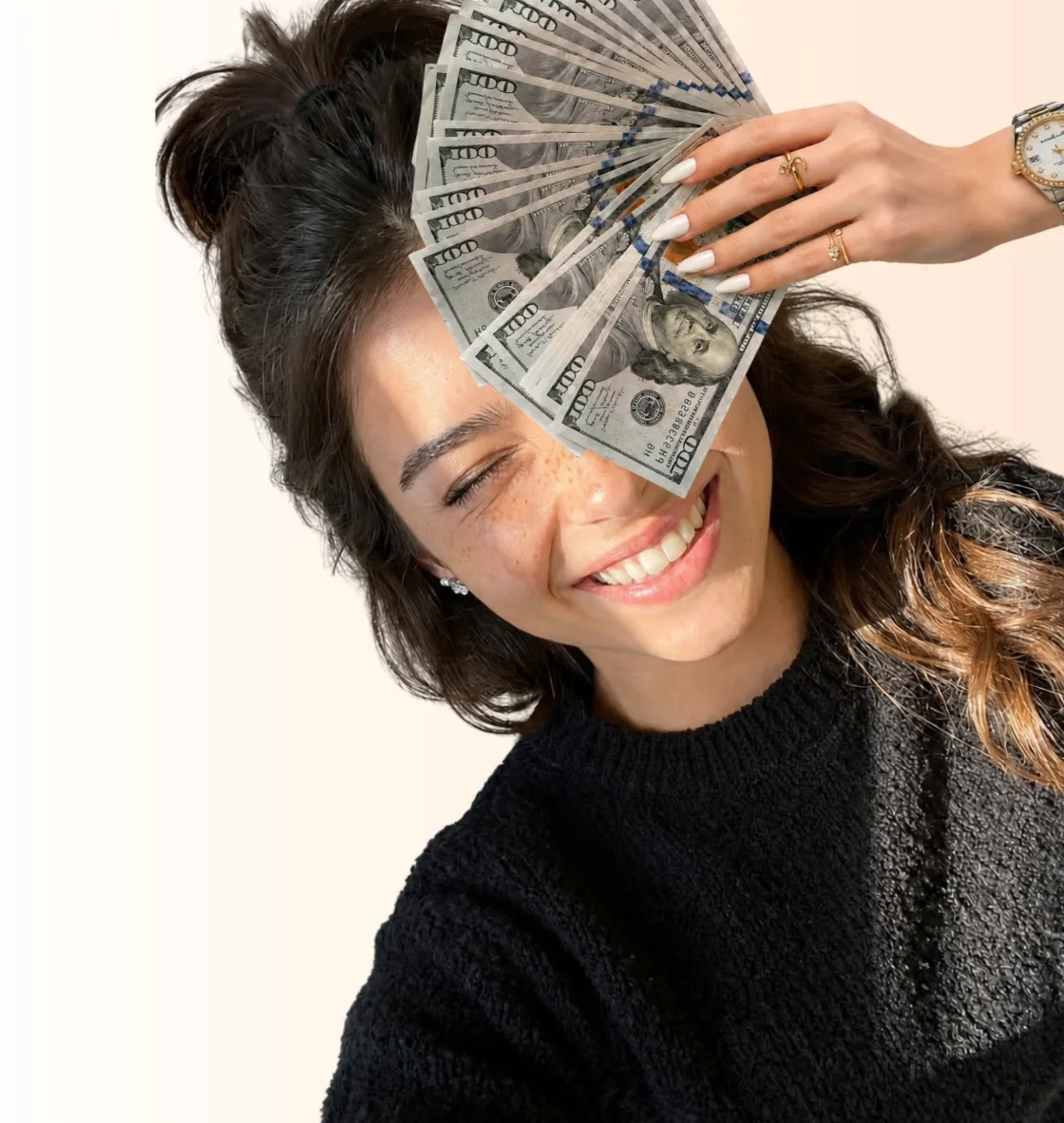 Smiling creator fanning out hundred dollar bills in front of her face
